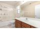 Bathroom featuring a shower with glass door, light-colored countertops, and wooden vanity at 10792 W Elm Ln, Avondale, AZ 85323