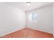 Modest bedroom with geometric flooring, a small window, and white walls at 10792 W Elm Ln, Avondale, AZ 85323