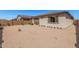 Low-maintenance backyard featuring desert landscaping, a covered patio, and a block wall at 12125 W Levi Dr, Avondale, AZ 85323