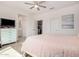 Cozy bedroom with a ceiling fan, light-colored walls, and a comfortable bed with pastel-colored bedding at 12125 W Levi Dr, Avondale, AZ 85323