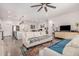 Open concept living space with modern furniture, a large television, and view into the kitchen at 12125 W Levi Dr, Avondale, AZ 85323