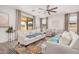 Bright living room with large windows, neutral-toned furniture, and a cozy atmosphere at 12125 W Levi Dr, Avondale, AZ 85323