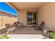 Cozy covered patio with wicker furniture and a sliding glass door at 12125 W Levi Dr, Avondale, AZ 85323