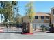 Gated entrance with black fencing in a community with beige buildings and palm trees at 1335 E June St # 113, Mesa, AZ 85203