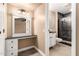 Bathroom features a vanity and a shower with black tile and glass door at 13628 N 109Th Ave, Sun City, AZ 85351