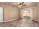 This light filled bedroom features a ceiling fan, and sliding glass door to your backyard retreat at 13628 N 109Th Ave, Sun City, AZ 85351