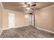 This bedroom offers a blank canvas with wood-look flooring, neutral walls, and a ceiling fan at 13628 N 109Th Ave, Sun City, AZ 85351