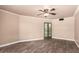 This bedroom offers a blank canvas with wood-look flooring, neutral walls, and unique french doors at 13628 N 109Th Ave, Sun City, AZ 85351