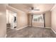 Bedroom with a fan and a window with gray curtains leading to the bathroom at 13628 N 109Th Ave, Sun City, AZ 85351