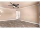 Bedroom features ceiling fan, neutral walls, and vinyl flooring with closet and storage at 13628 N 109Th Ave, Sun City, AZ 85351