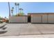 Charming home exterior featuring a gated entrance, lush palm trees, and an attached garage at 13628 N 109Th Ave, Sun City, AZ 85351