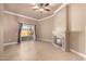 Living room features a ceiling fan, decorative fireplace, and a sliding glass door with access to the backyard at 13628 N 109Th Ave, Sun City, AZ 85351