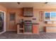 Outdoor bar area with grill, mini-fridge, and cabinetry, ideal for entertaining guests at 13628 N 109Th Ave, Sun City, AZ 85351