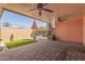 Inviting covered patio with brick flooring, built-in seating, and serene backyard view at 13628 N 109Th Ave, Sun City, AZ 85351