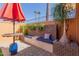 Comfortable patio seating area with lush plants, colorful pillow, and a decorative table at 13628 N 109Th Ave, Sun City, AZ 85351