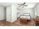 Well-lit bedroom with a ceiling fan, hardwood floors, and ample natural light from the windows at 14027 N 32Nd St, Phoenix, AZ 85032