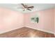 Bedroom featuring modern ceiling fan, neutral walls, wood-look flooring, and window at 14027 N 32Nd St, Phoenix, AZ 85032