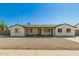 Charming single-story home featuring a covered porch with stately stone pillars and desert landscaping at 14027 N 32Nd St, Phoenix, AZ 85032