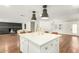 Open-concept kitchen island with stone countertops, pendant lighting, and ample seating at 14027 N 32Nd St, Phoenix, AZ 85032