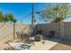 Outdoor patio with fire pit and seating surrounded by privacy wall at 14027 N 32Nd St, Phoenix, AZ 85032