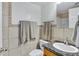 Bathroom features tiled walls, granite countertop, and modern fixtures at 151 E Broadway Rd # 102, Tempe, AZ 85282