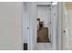 View of a hallway leading to a bedroom, featuring tiled floors and neutral wall color at 151 E Broadway Rd # 102, Tempe, AZ 85282