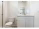 Bright, modern bathroom with marble countertops and sleek white cabinetry and tiled shower at 15378 W Cottontail Ln, Surprise, AZ 85387