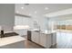 Stylish kitchen featuring an island, stainless steel dishwasher, and a view of the backyard at 15378 W Cottontail Ln, Surprise, AZ 85387