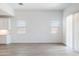 Open-concept living room with neutral walls, tile flooring, and abundant natural light at 15378 W Cottontail Ln, Surprise, AZ 85387