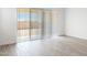 Bright living room featuring tile floors and a sliding glass door to the backyard at 15378 W Cottontail Ln, Surprise, AZ 85387