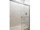 Beautifully tiled shower featuring marble-look walls and a modern glass door at 15378 W Cottontail Ln, Surprise, AZ 85387