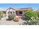 Desert landscaped backyard featuring a covered patio, solar panels, and native plants at 16017 W Wildflower Dr, Surprise, AZ 85374