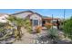 Desert landscaped backyard featuring a covered patio, native plants, and a rock water feature at 16017 W Wildflower Dr, Surprise, AZ 85374