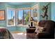 Bright bedroom nook featuring a brown recliner positioned near a window and side table at 16017 W Wildflower Dr, Surprise, AZ 85374