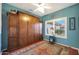 Charming bedroom featuring a Murphy bed with built-in cabinets and a colorful area rug at 16017 W Wildflower Dr, Surprise, AZ 85374