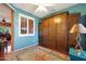 Inviting bedroom showcasing a Murphy bed with wooden cabinetry and decorative rug at 16017 W Wildflower Dr, Surprise, AZ 85374