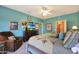 Spacious main bedroom complete with dresser and a relaxing chair, brightened by natural light at 16017 W Wildflower Dr, Surprise, AZ 85374