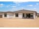 The backyard is spacious and undeveloped, offering a blank canvas for outdoor living and landscaping at 16749 W Whispering Wind Dr, Surprise, AZ 85387