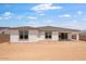 The empty backyard is spacious and undeveloped, offering a blank canvas for outdoor living and landscaping at 16749 W Whispering Wind Dr, Surprise, AZ 85387