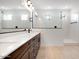 Spacious bathroom with double sinks, walk-in shower, and tile flooring at 16749 W Whispering Wind Dr, Surprise, AZ 85387