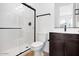 Modern bathroom featuring walk-in shower, wood-style floor, and sleek fixtures at 16749 W Whispering Wind Dr, Surprise, AZ 85387