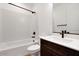 Well-lit bathroom with a bathtub, shower combo, and a vanity with a dark wood cabinet at 16749 W Whispering Wind Dr, Surprise, AZ 85387