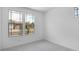 Bright, carpeted bedroom featuring large windows with neighborhood views at 16749 W Whispering Wind Dr, Surprise, AZ 85387