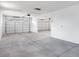 A very large garage featuring multiple garage doors, lights, and space at 16749 W Whispering Wind Dr, Surprise, AZ 85387