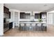 Beautiful kitchen features stainless appliances, dark cabinets, white countertops and subway tile backsplash at 16749 W Whispering Wind Dr, Surprise, AZ 85387