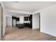 Open-concept living space featuring hardwood floors and a view into the modern kitchen at 16749 W Whispering Wind Dr, Surprise, AZ 85387