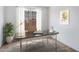 Bright office space with a modern desk setup, large window, and minimalist decor at 16749 W Whispering Wind Dr, Surprise, AZ 85387