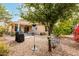 Backyard with covered patio, desert landscaping, and trees provides shade and a tranquil outdoor setting at 17532 W Caribbean Ln, Surprise, AZ 85388