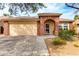 Charming single-story home featuring a two-car garage and a lovely front porch at 17532 W Caribbean Ln, Surprise, AZ 85388