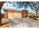 Spacious single-story home with a large driveway and desert landscaping at 17532 W Caribbean Ln, Surprise, AZ 85388